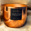 Copper candle holder with a label on a textured fabric background